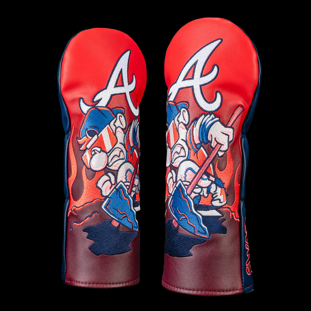 Front and angled view of an Atlanta Braves fairway cover featuring a cartoon Braves mascot in mirrored sunglasses and headphones holding a tomahawk beneath a large Braves "A," with bold red, navy, and white artwork.