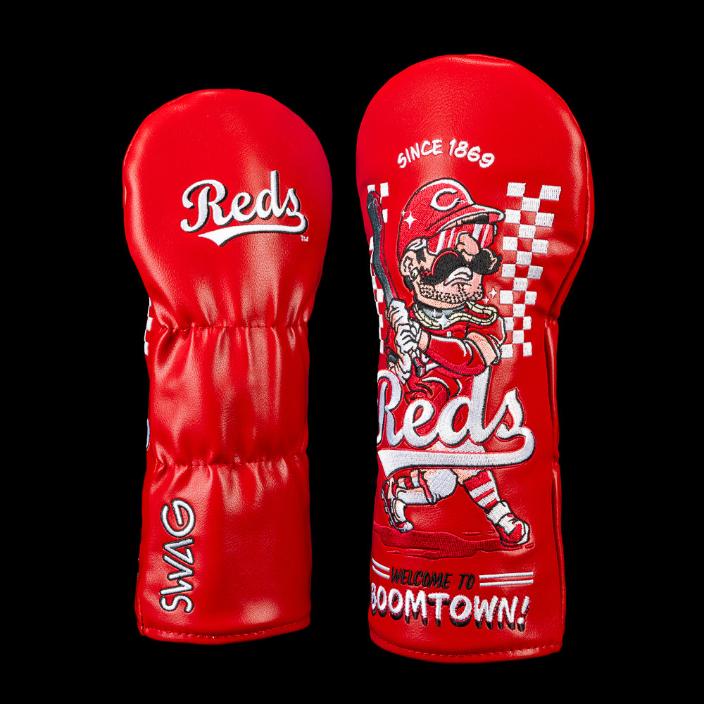 SWAG Golf Cincinnati Reds fairway cover shown front and back with an embroidered Reds script logo on the reverse and artwork featuring a mustached batter in a vintage Reds uniform and sunglasses, checkerboard racing graphics, "Since 1869" lettering, oversized Reds script, and "Welcome to Boomtown!" across the bottom.