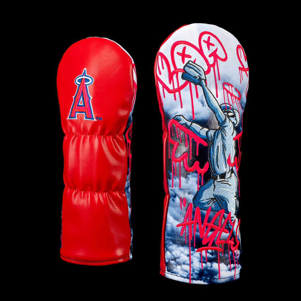 SWAG Golf Los Angeles Angels fairway cover shown front and back, featuring a red back panel with the Angels logo and a baseball player with dripping red Angels graffiti over a cloud-filled sky.