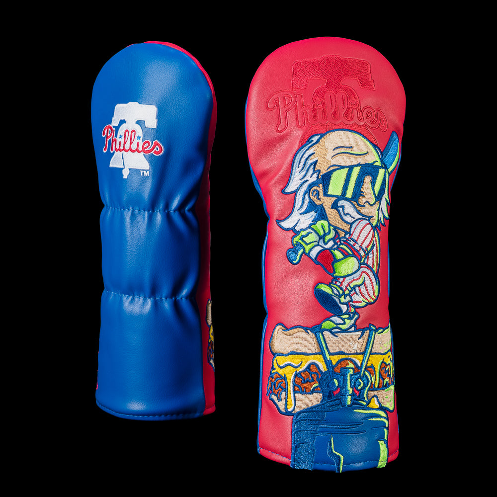 SWAG Golf Philadelphia Phillies fairway cover shown front and back with the Phillies logo embroidered on the reverse and artwork featuring a retro slugger sporting oversized shades, gripping a bat while standing over an iconic Philly cheesesteak.