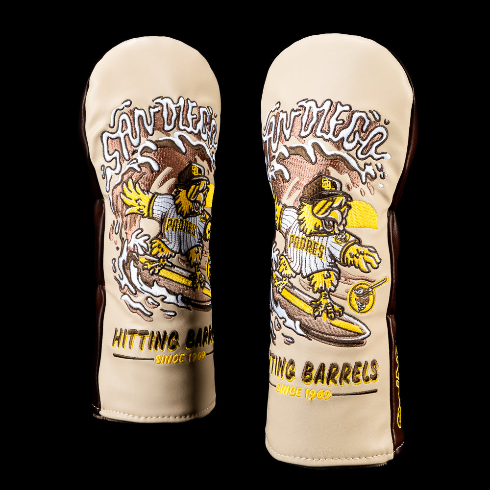 SWAG Golf San Diego Padres fairway cover featuring a bird riding a surfboard through an ocean wave with bold "SAN DIEGO" artwork and "HITTING BARRELS SINCE 1969" stitched below, finished in vintage Padres brown, gold, and cream colors.