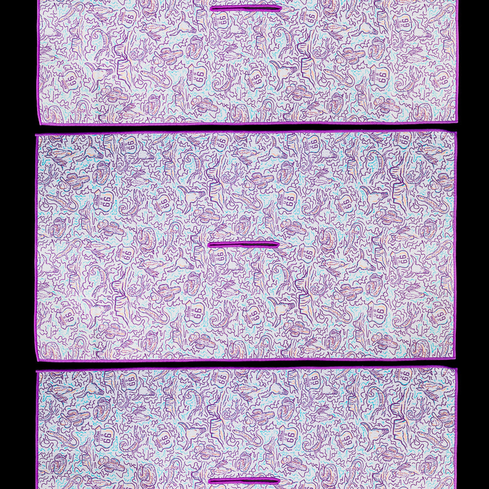 Golf towel featuring an all over pattern of hand drawn coastal illustrations including snakes, desert, and Route 66 markers in purple, teal, and white.