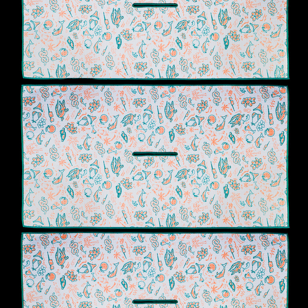 Florida golf towel featuring an all over pattern of hand drawn illustrations including alligators, flamingos, oranges, palm trees, seashells, boats, tropical flowers, golf carts, seafood, beach icons, and Florida inspired graphics in teal and coral.