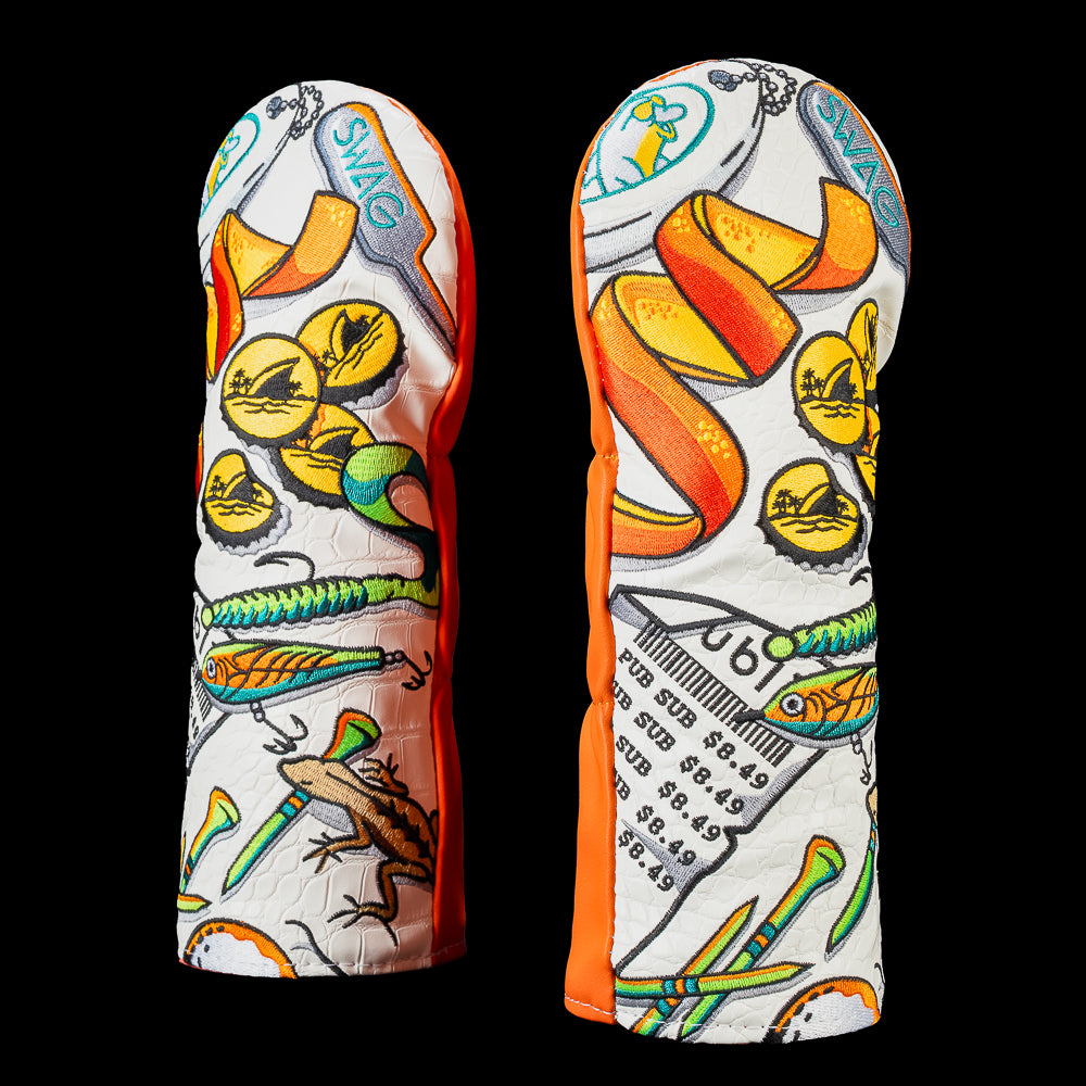 Florida fairway wood cover featuring embroidered illustrations of oranges, fishing lures, golf tees, sunglasses, palm trees, and Florida inspired essentials on a white background with orange side panels.