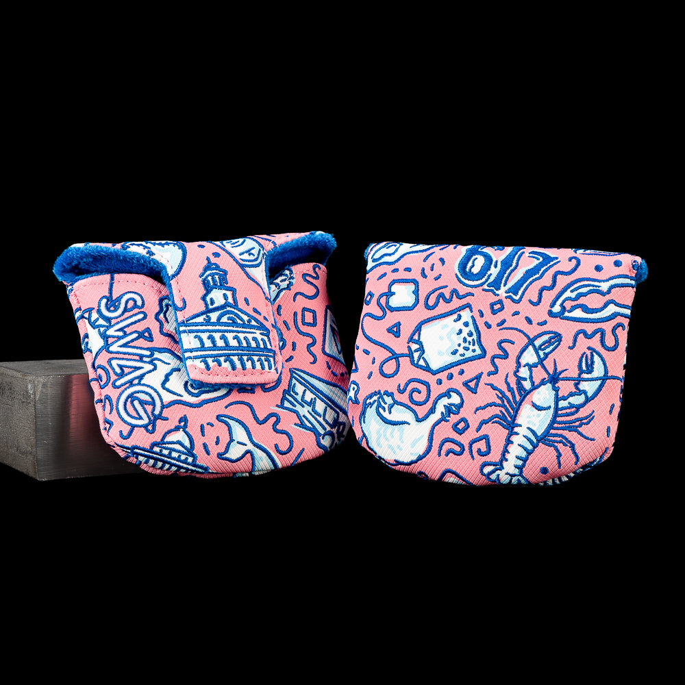 Open and closed views of the SWAG Golf Locals Only Boston mallet putter cover featuring embroidered Boston-inspired artwork with city landmarks, waterfront elements, baseball-inspired graphics, and neighborhood icons in pink, navy, and light blue with a navy plush interior.