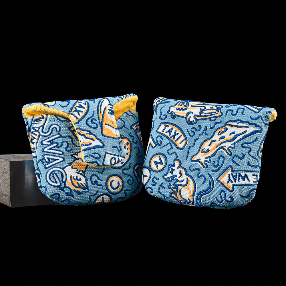 SWAG Golf Locals Only New York mallet putter cover featuring embroidered New York-inspired artwork with pizza, a taxi cab, subway symbols, a rat, city signage, and neighborhood graphics on a blue background with a yellow plush interior.