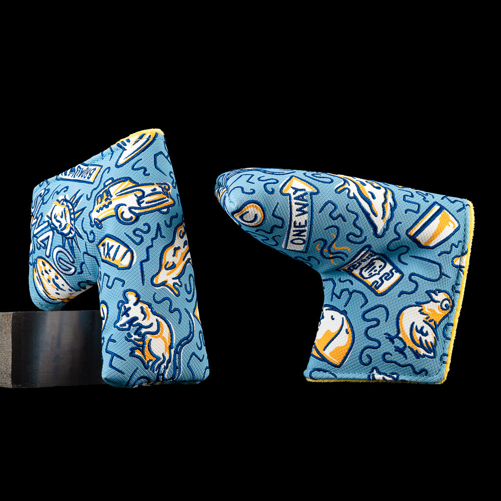 SWAG Golf Locals Only New York blade putter cover featuring embroidered New York-inspired artwork with a taxi cab, pizza slice, subway graphics, city signs, a rat, and neighborhood icons on a blue background.