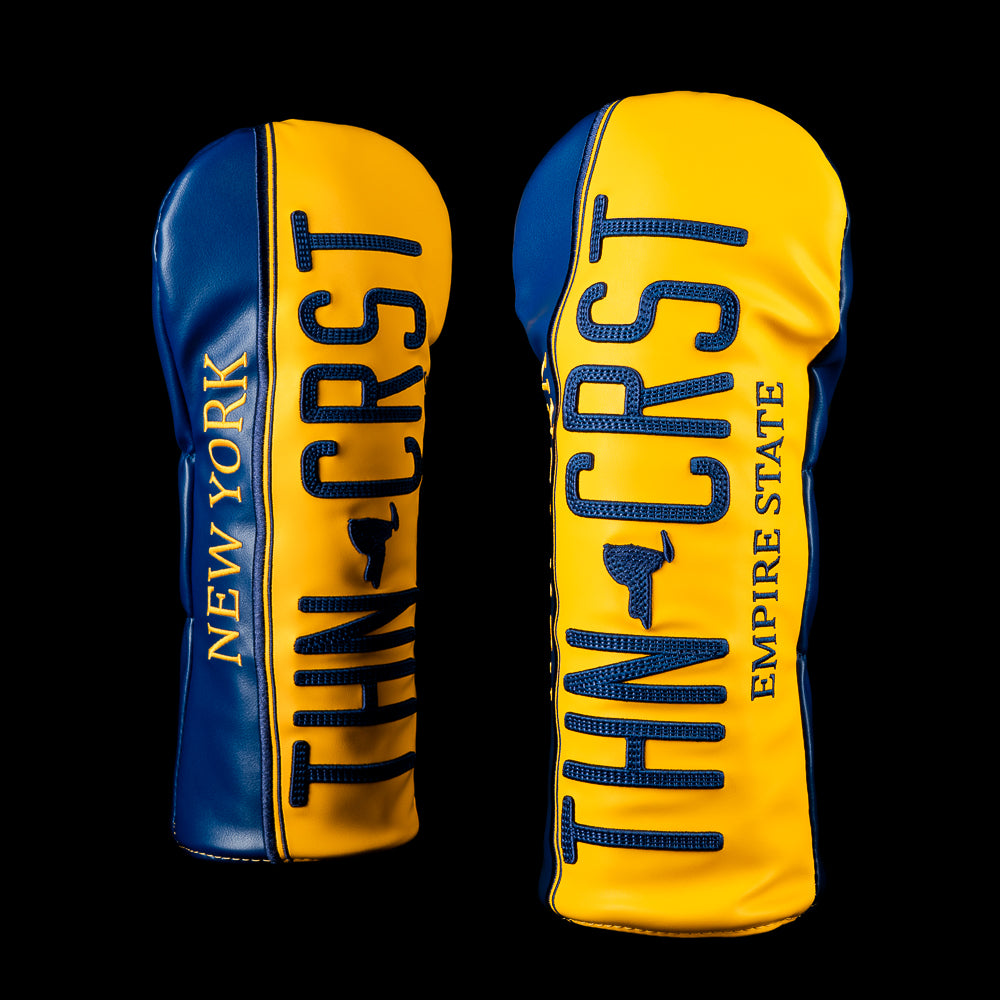 SWAG Golf New York Thin Crust driver cover featuring a yellow and blue New York license plate-inspired design with oversized "THN CRST" lettering, "Empire State" text, and blue side panels.