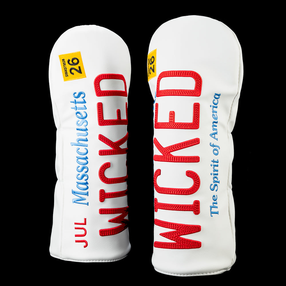 Front of the SWAG Golf Boston Wicked driver headcover featuring a Massachusetts license plate-inspired design with oversized red "WICKED" lettering, blue "The Spirit of America" text, a July 2026 registration sticker, and the SWAG shield logo on the back.