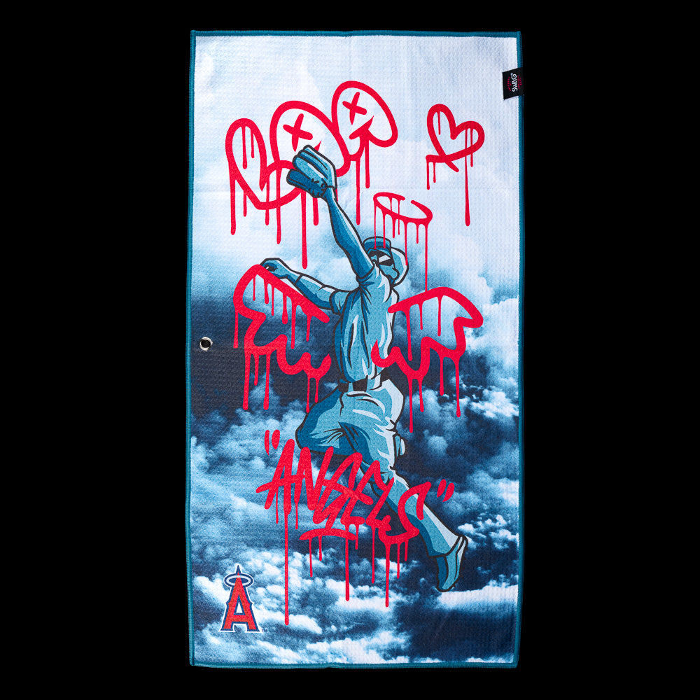 Statue of an angel reaching through clouds covered in red graffiti reading "Angels" on an officially licensed Los Angeles Angels MLB golf towel by SWAG Golf.