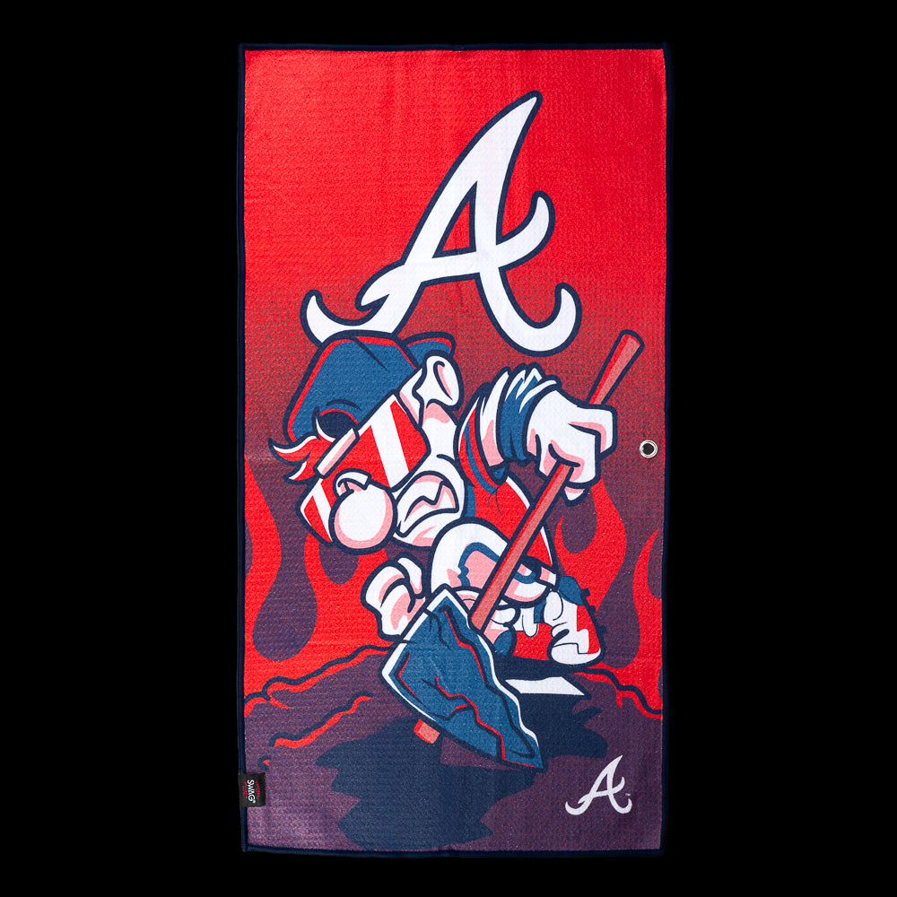 Cartoon character digging through red dirt beneath a large Atlanta Braves "A" logo with flames in the background on an officially licensed Atlanta Braves MLB golf towel by SWAG Golf.