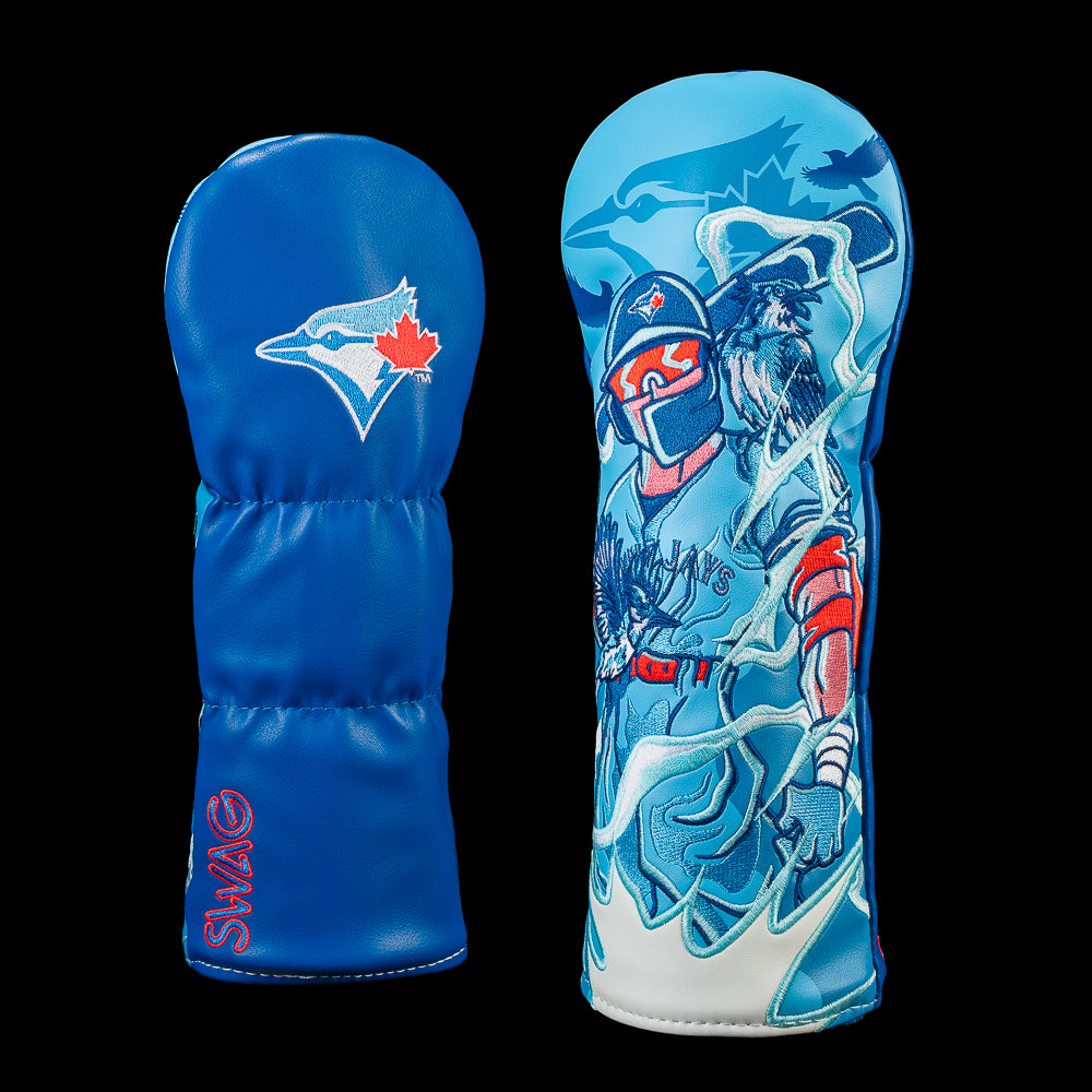 SWAG Golf Toronto Blue Jays fairway cover shown front and back with an embroidered Blue Jays logo on the reverse and detailed artwork of a Blue Jays batter surrounded by blue jays, swirling wind, and team graphics.