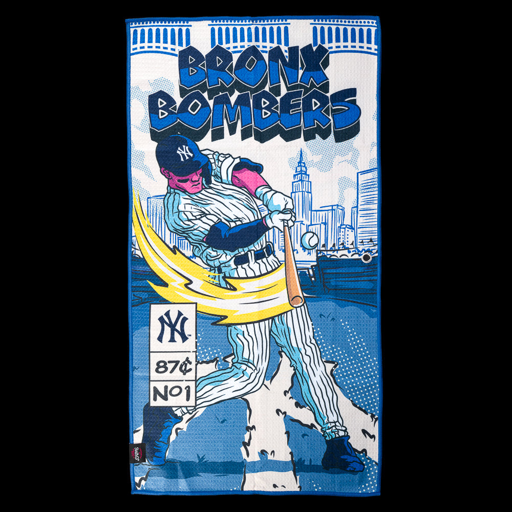 Yankees batter swinging in front of the New York skyline beneath bold "Bronx Bombers" lettering on an officially licensed New York Yankees MLB golf towel by SWAG Golf.