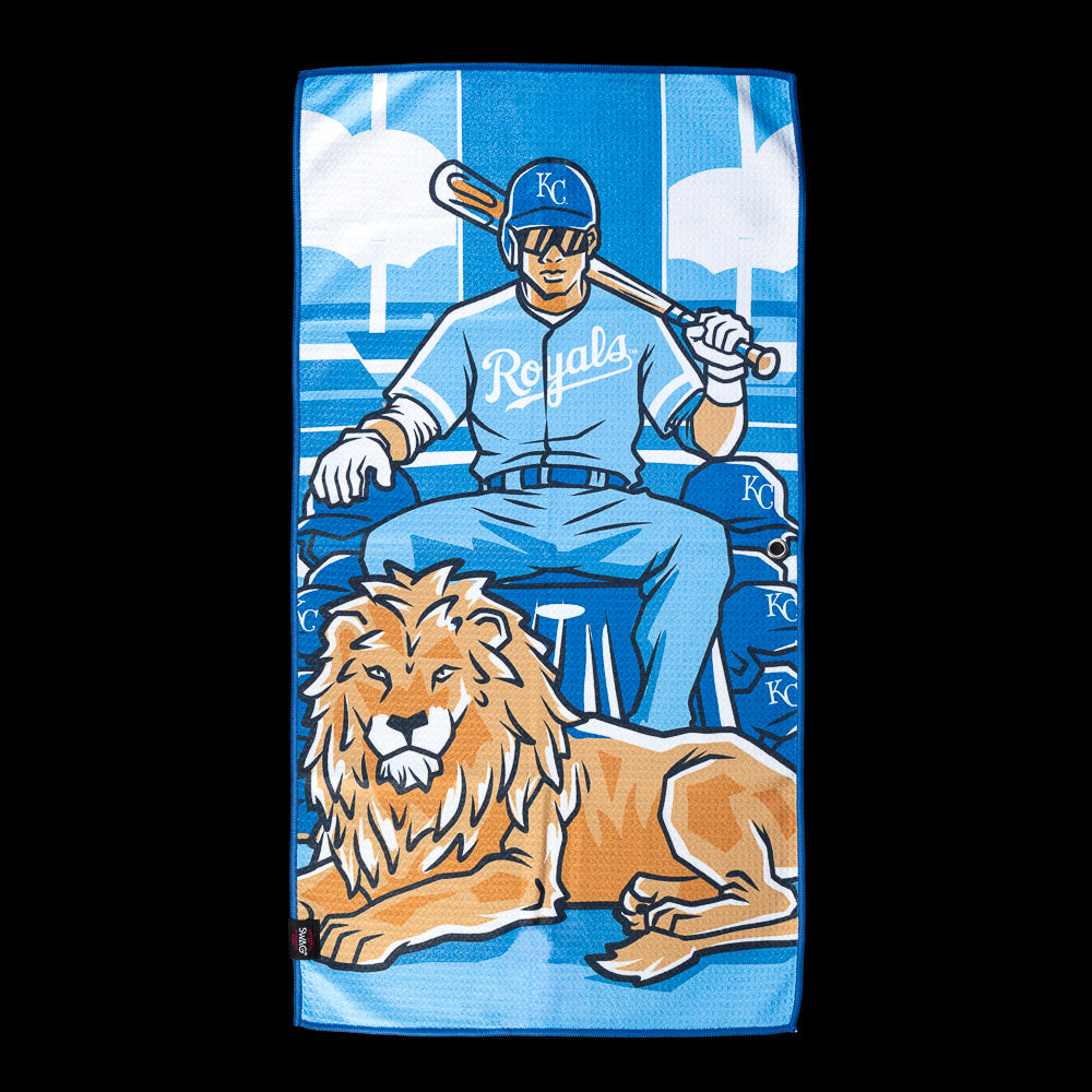 Royals player seated on a throne with a lion at his feet beneath a blue sky on an officially licensed Kansas City Royals MLB golf towel by SWAG Golf.