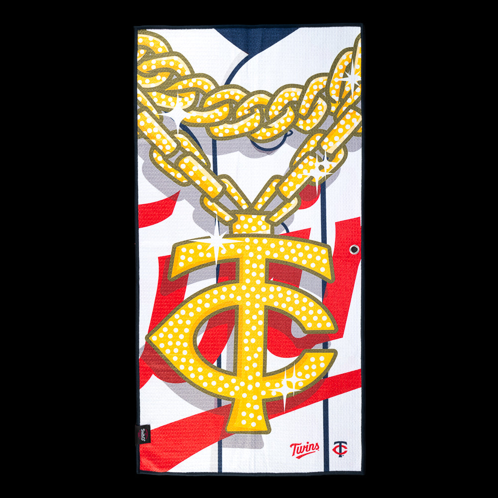 Oversized diamond Twins logo hanging from a sparkling gold chain on an officially licensed Minnesota Twins MLB golf towel by SWAG Golf.