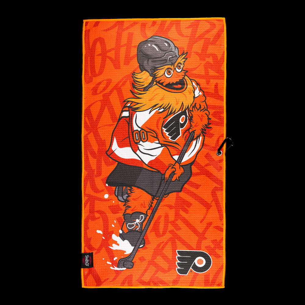 Orange Philadelphia Flyers golf towel with a shaggy hockey player, tonal graffiti pattern and Flyers logo.