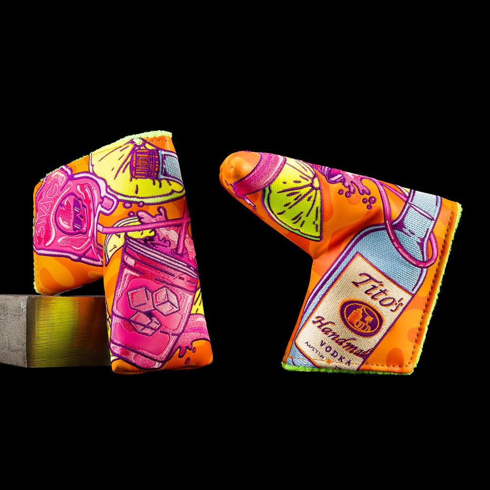 SWAG Golf Tito's Splash of Grape blade putter cover featuring a Tito's Vodka bottle, purple grape cocktail, lime wedges, citrus slices, and colorful embroidered artwork.