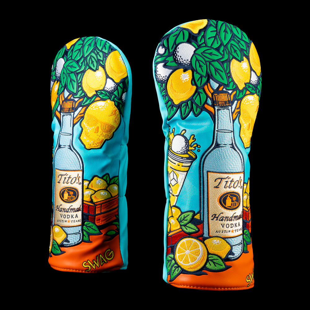 SWAG Golf Tito's & Lemonade driver cover featuring a vibrant turquoise and orange design with a Tito's Vodka bottle, lemons, citrus slices, leaves, a cocktail with a golf ball garnish, and embroidered summer artwork.