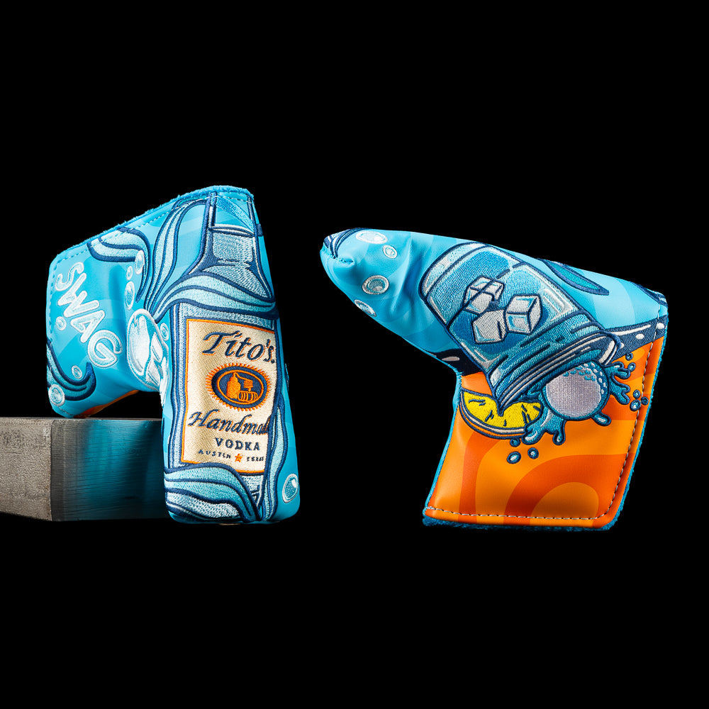 SWAG Golf Tito's Water Hazard blade putter cover featuring a Tito's Vodka bottle, ice cubes, blue water graphics, a golf ball splash, and vibrant embroidered cocktail.
