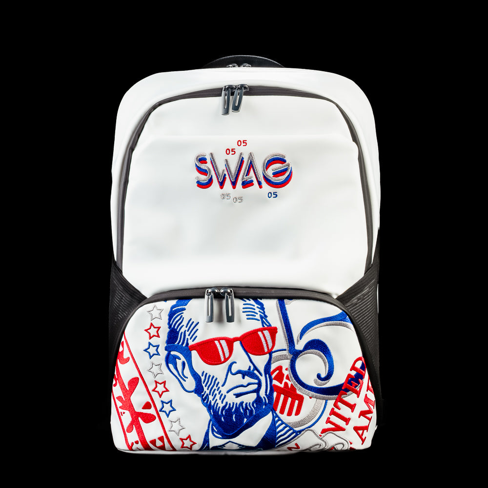 Front view of the RWB Gigantic Lincoln Backpack featuring patriotic red, white, and blue Abraham Lincoln artwork, a large front zip pocket, and embroidered SWAG logo.