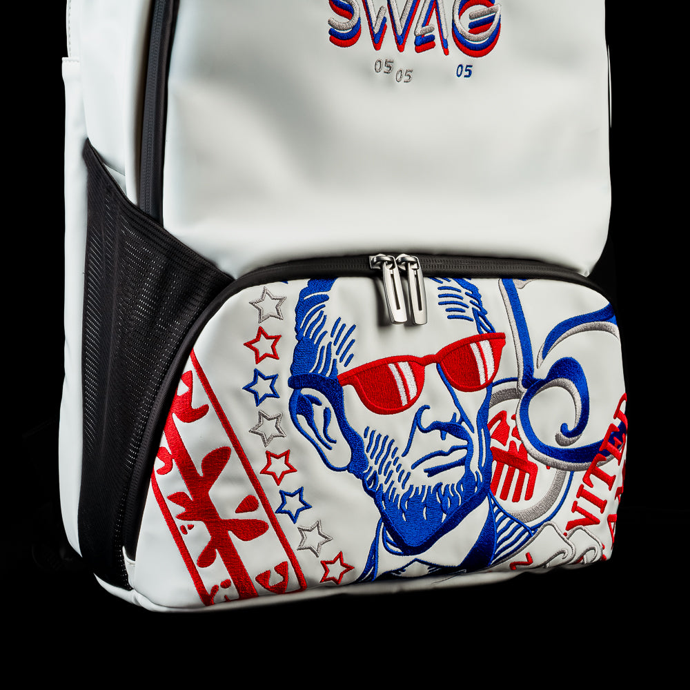 Close-up angled view of the front of the RWB Gigantic Lincoln Backpack showcasing Abraham Lincoln artwork, patriotic red, white, and blue graphics, and the front zippered pocket.