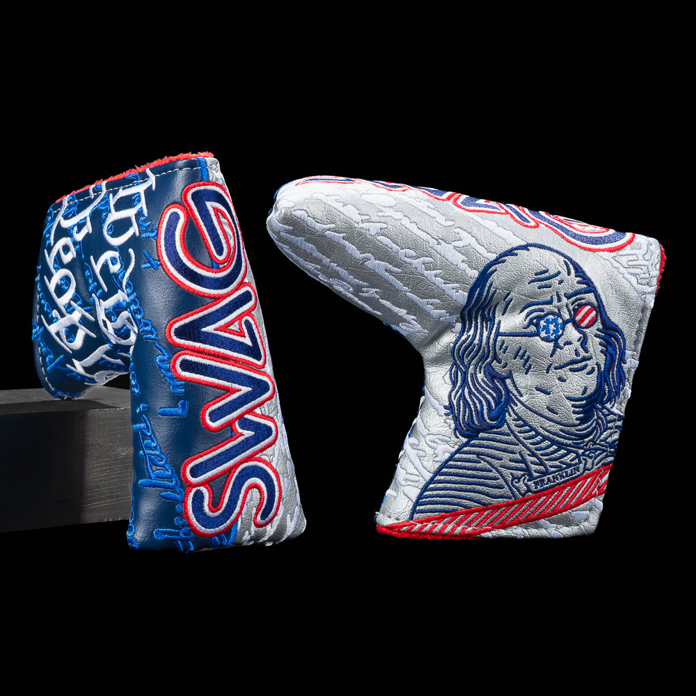 SWAG Golf We The People blade cover featuring embroidered Benjamin Franklin artwork, patriotic red white and blue detailing, oversized SWAG lettering, and textured currency inspired graphics .
