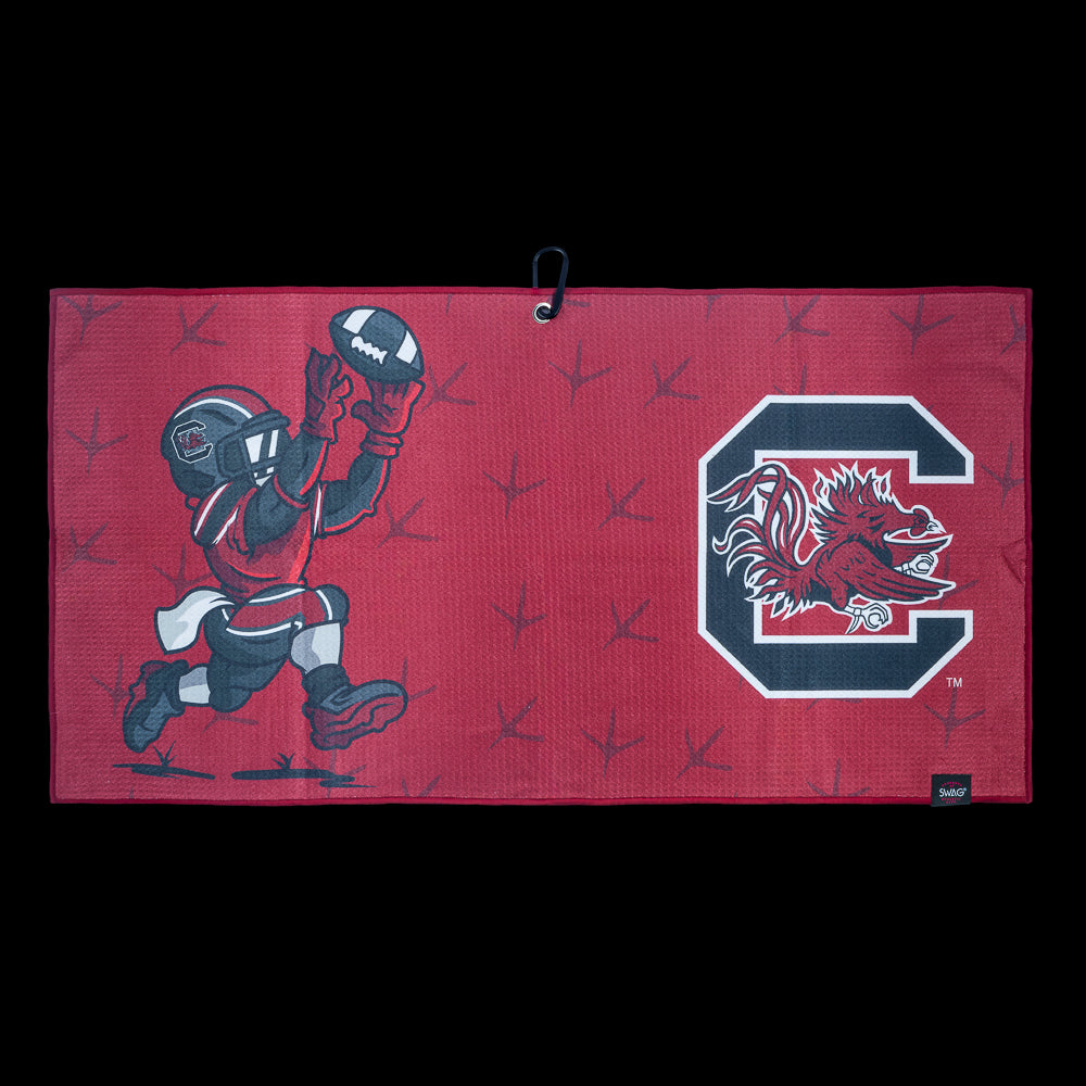 Red golf towel with University of South Carolina Gamecocks football player graphic and logo on a black background