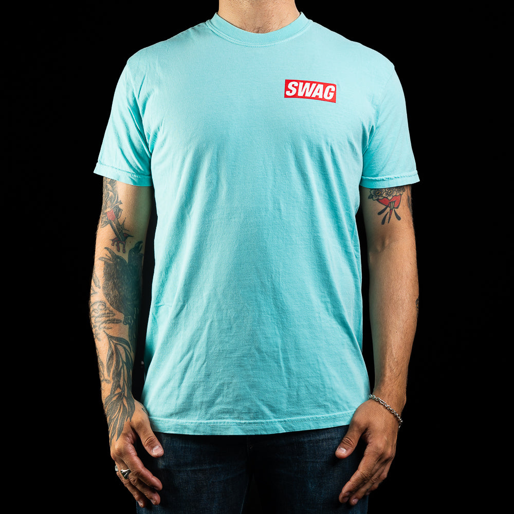 SWAG Golf teal men's short sleeve graphic t-shirt with flipper print and SWAG logo.