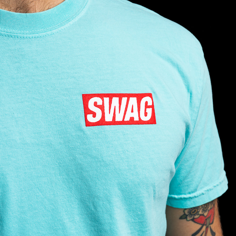 SWAG Golf teal men's short sleeve graphic t-shirt with flipper print and SWAG logo.