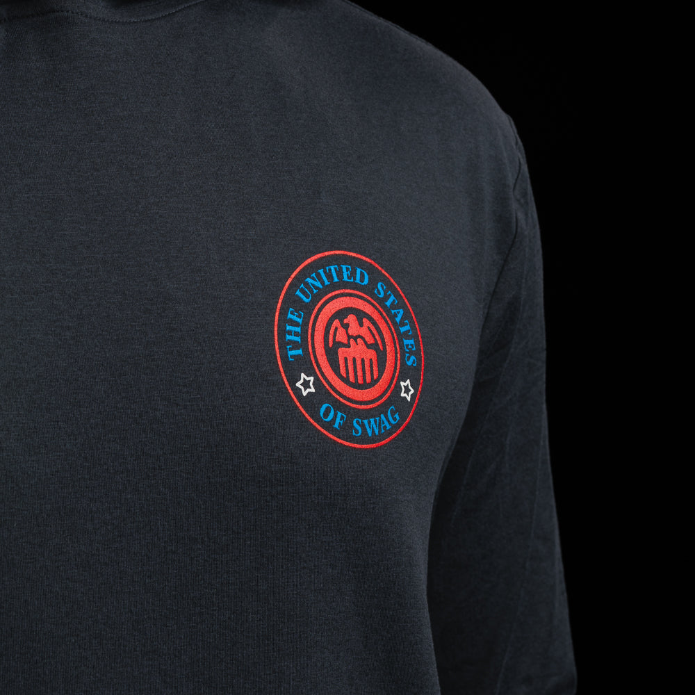 Person wearing a navy long-sleeve hoodie with a United States of SWAG logo on the chest against a black background