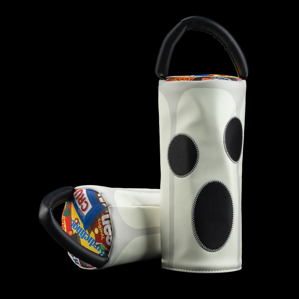A pair of white glow-in-the-dark driver golf headcovers with black circular accents and black handles, displayed against a solid black background.