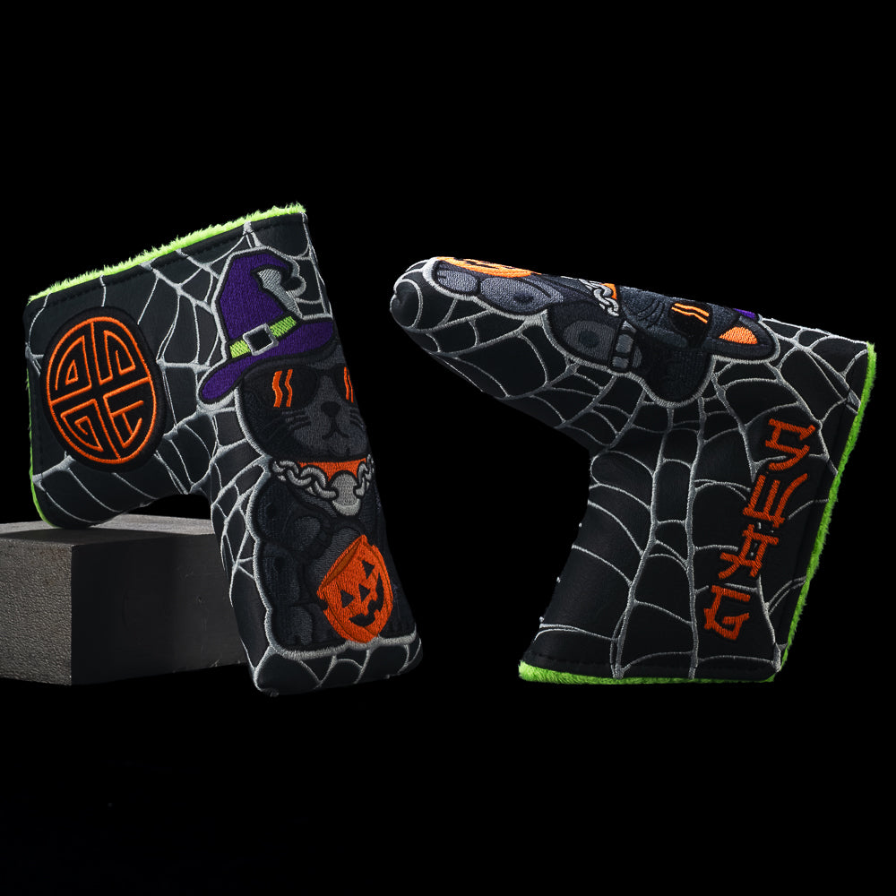 SWAG Golf unlucky black cat wearing a purple hat with an orange pumpkin bucket on a spiderweb blade golf headcover with neon green fur.