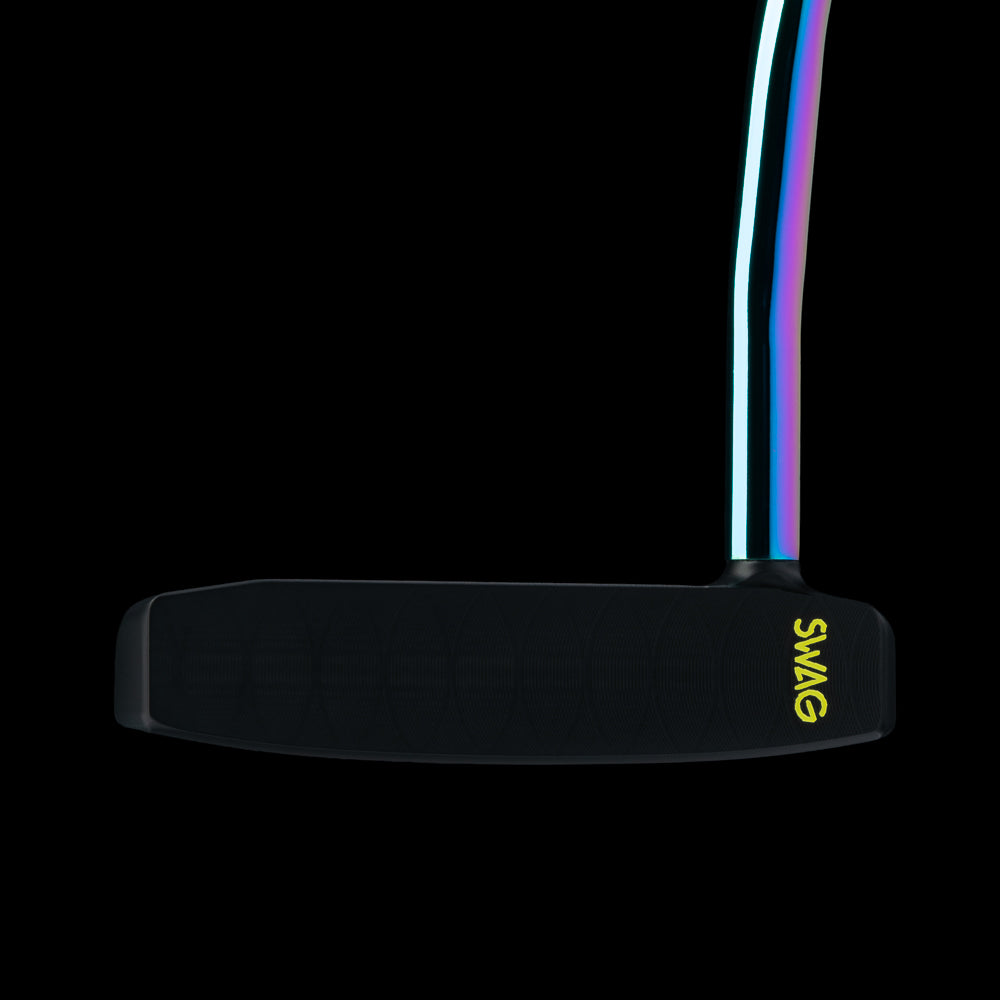 A close-up studio shot of a black golf putter head with a vibrant iridescent rainbow-colored shaft against a solid black background. The brand name 'SWAG' is printed in yellow on the side of the putter head.