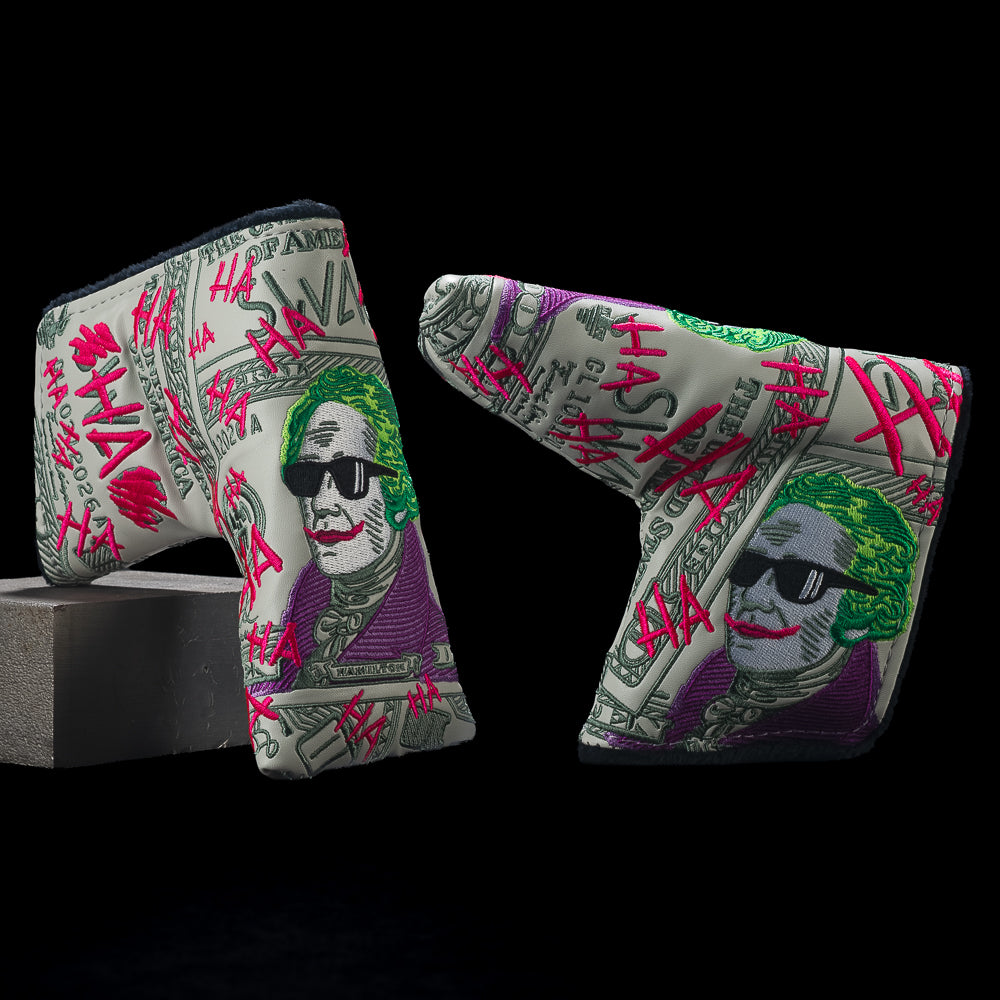 Two sides of SWAG Golf Defaced Hamilton blade headcover with pale-green bill art, green-haired portrait, sunglasses, and pink graffiti.