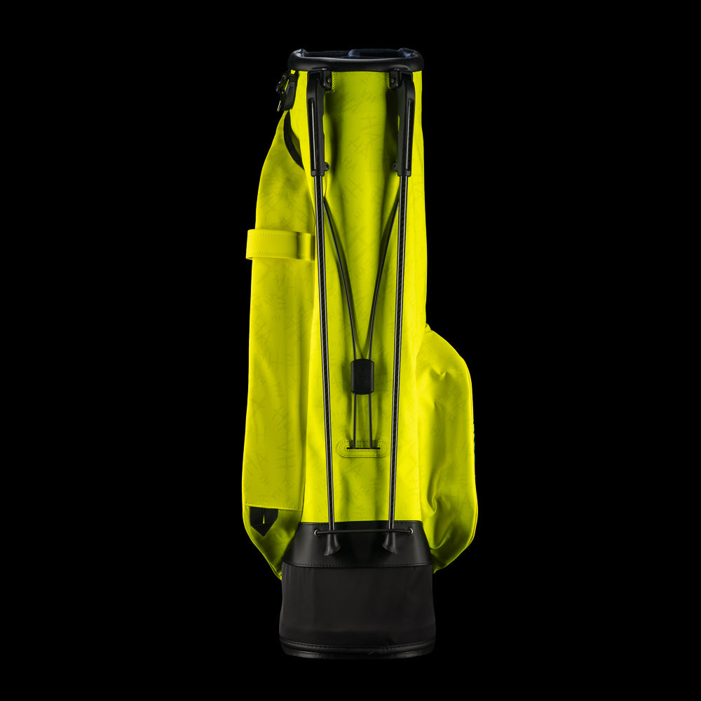 SWAG Golf x Vessel VLS Lux golf stand bag with neon yellow material and embroidered Defaced Franklin design on pink dollar bill themed panels.
