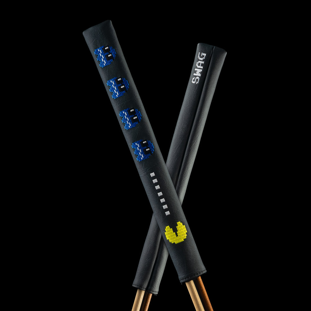 Crossed black SWAG Golf Hack-Man Ghosts alignment sticks covers showing blue pixel ghosts, white squares, a yellow character, and white SWAG lettering.