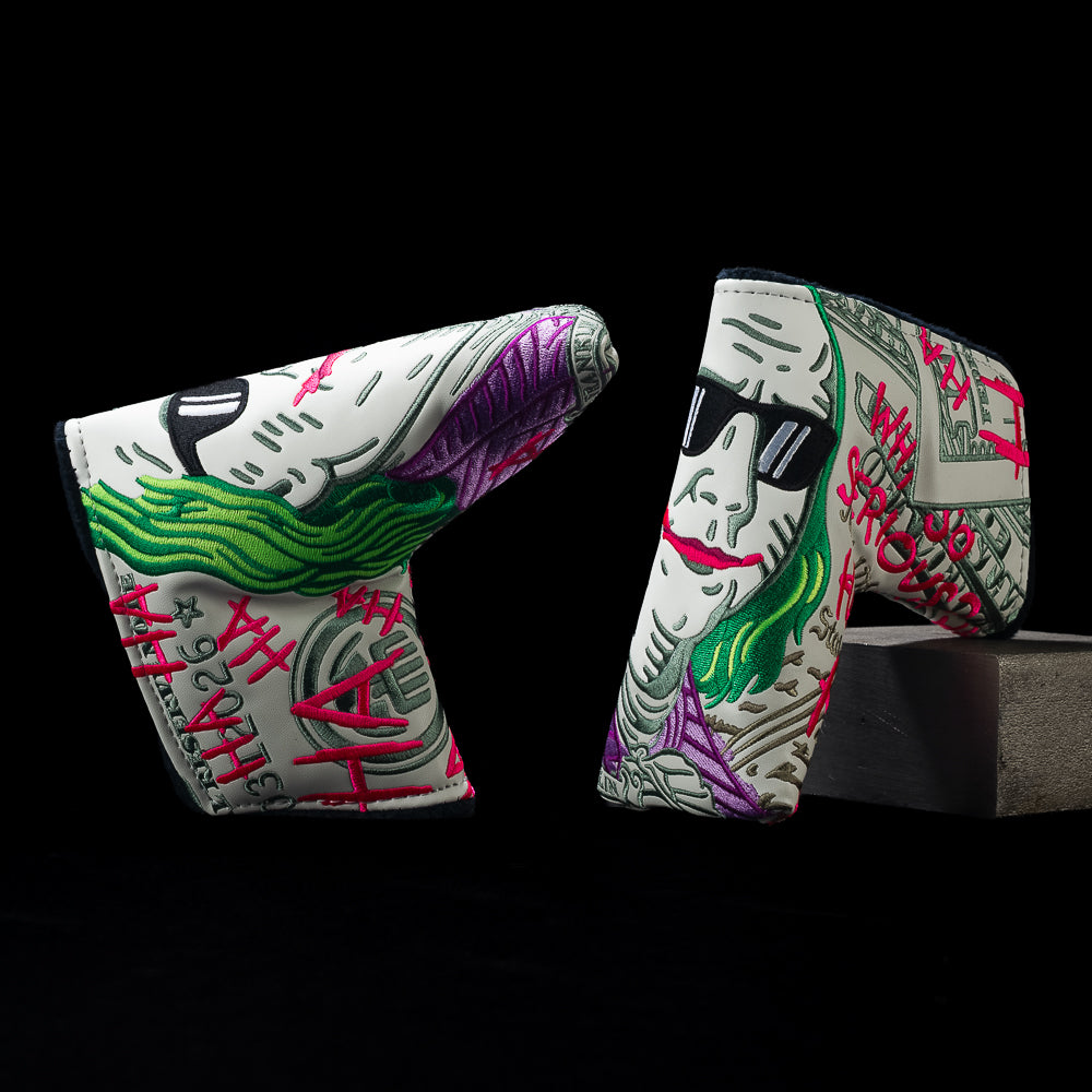 Two sides of SWAG Golf Jumbo Defaced Franklin blade headcover with gray bill art, green-haired portrait, sunglasses, and pink graffiti.