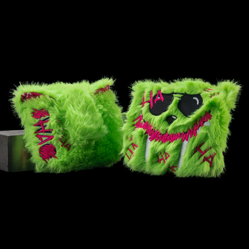 Two views of SWAG Golf Defaced LaBooster mallet cover with neon-green fur, black eyes, a pink grin, and pink graffiti.