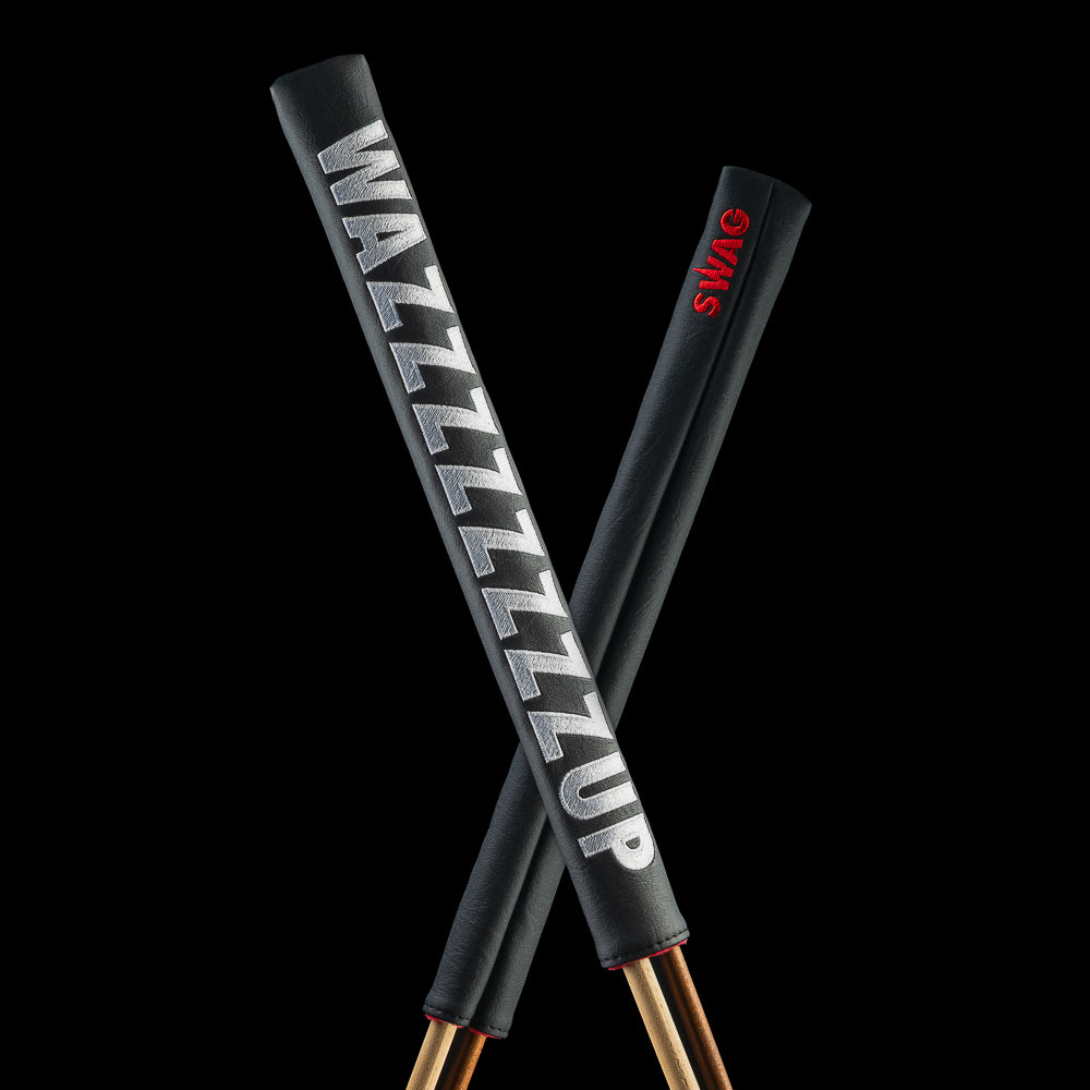 Crossed black SWAG Golf Wazzzzzzzzup alignment sticks covers with oversized white lettering on one side and a small red SWAG logo on the reverse.