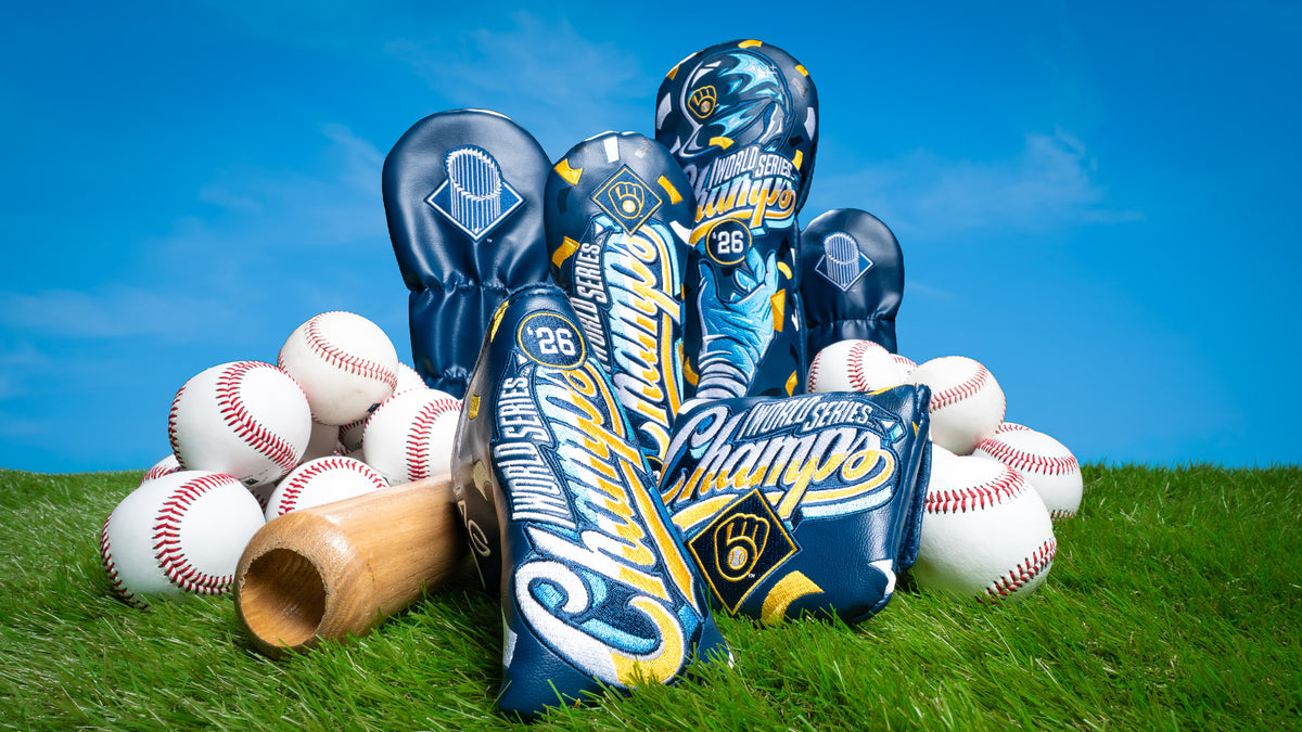 SWAG Golf x Milwaukee Brewers officially licensed 2026 World Series Champs golf headcovers on grass with a bat and baseballs.