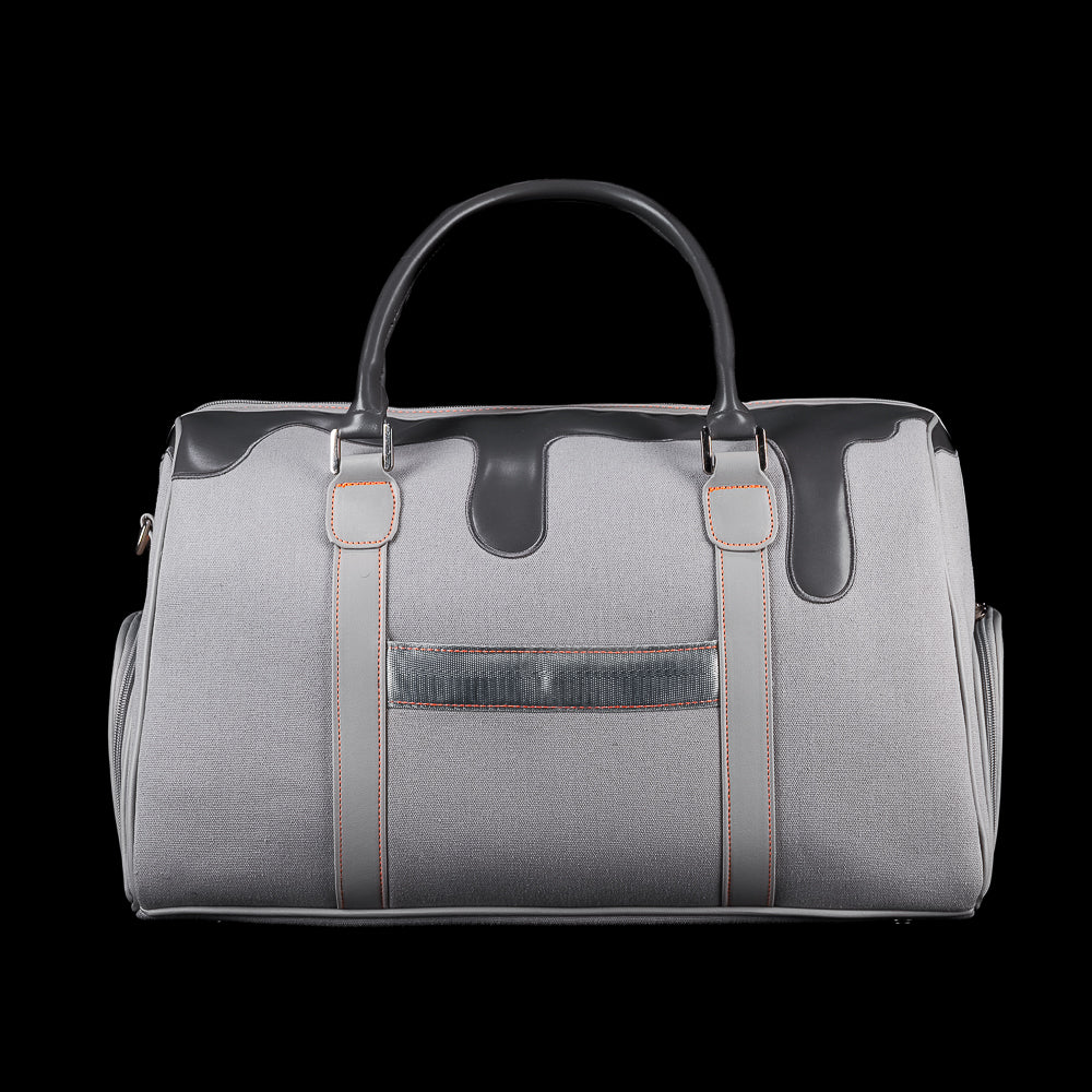 Back view of SWAG Golf Dripping Duffle Bag with grey body, black drip panel, orange stitching, and rear utility pocket.