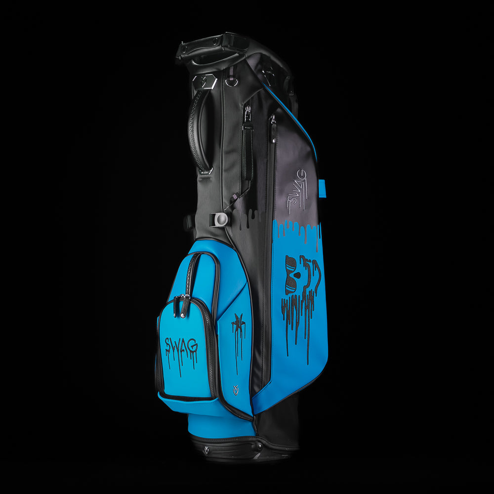 Blue and black SWAg Golf x Vessel golf stand bag with 'Don't Give a Putt' and 'Swag' text on a black background