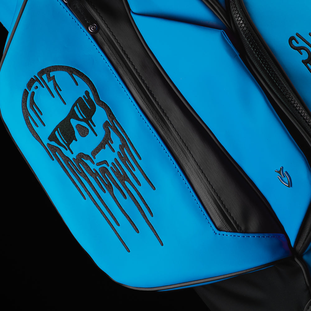 Blue and black SWAg Golf x Vessel golf stand bag with 'Don't Give a Putt' and 'Swag' text on a black background