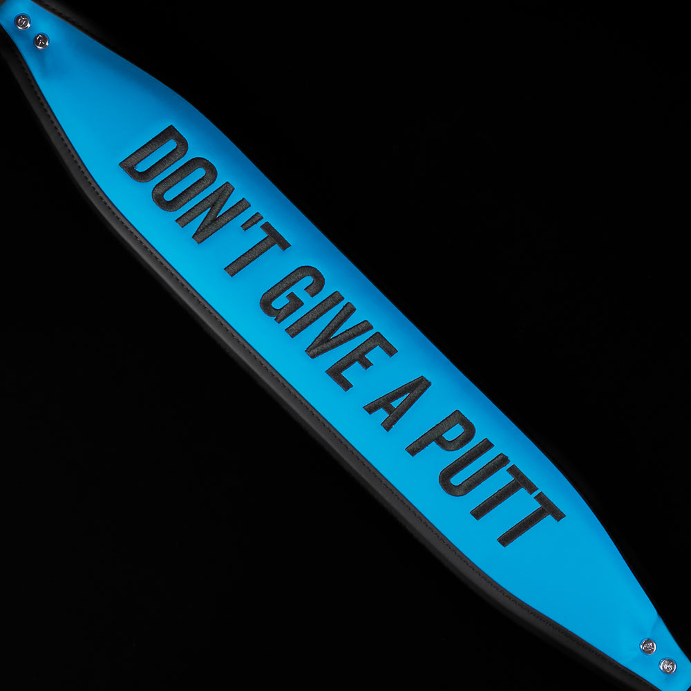 Blue and black SWAg Golf x Vessel golf stand bag with 'Don't Give a Putt' and 'Swag' text on a black background
