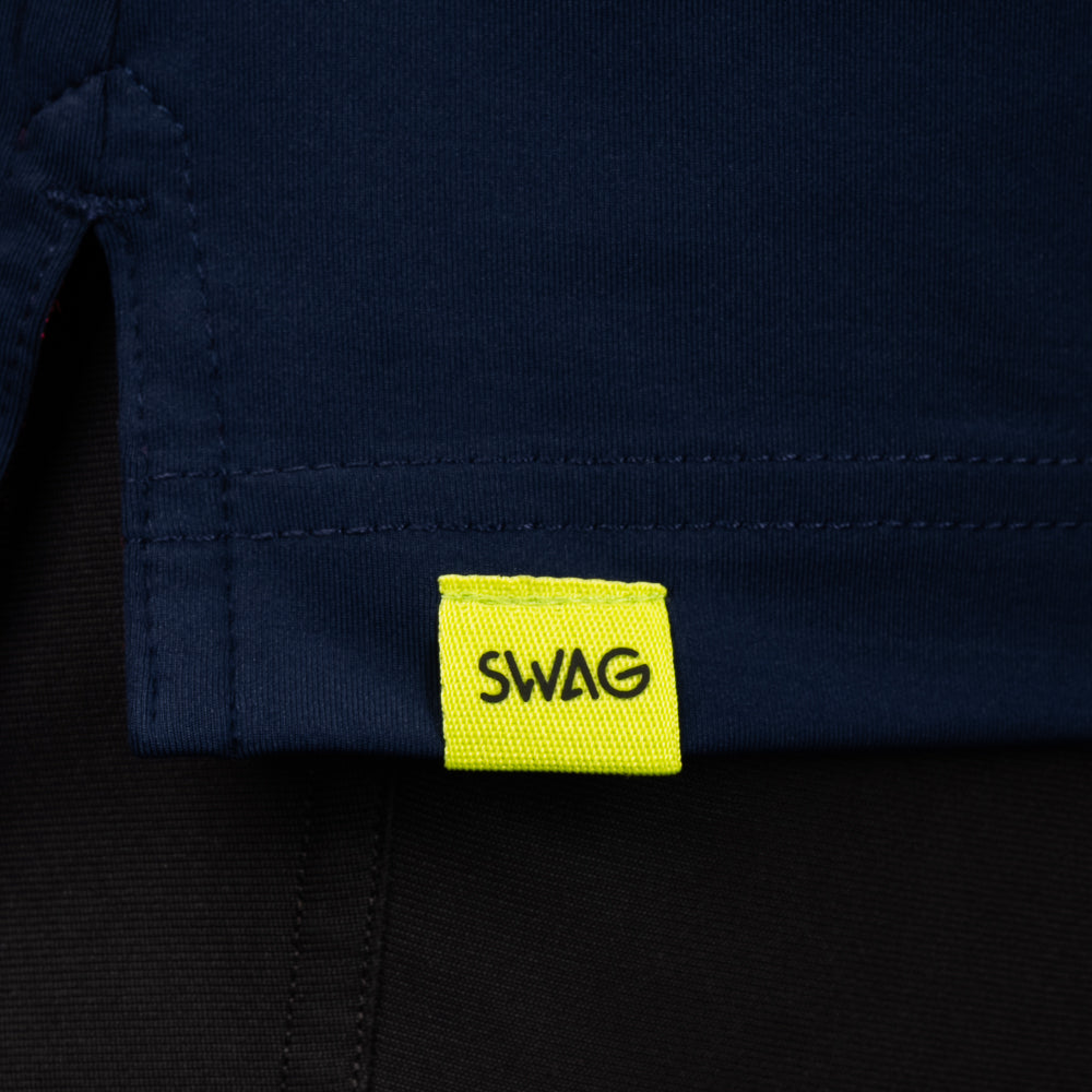 SWAG Golf Navy Aces Classic Polo hem detail with signature SWAG woven tag on performance golf shirt