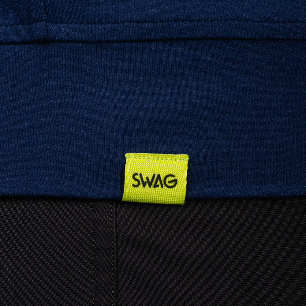 SWAG Golf Navy Club Quarter-Zip hem detail with signature SWAG woven tag on performance golf pullover