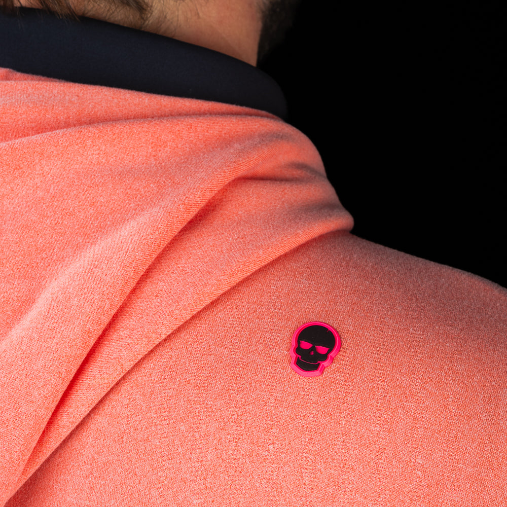 Back shoulder detail of SWAG Golf Heathered Peach Lounge Hoodie featuring the signature pink skull logo