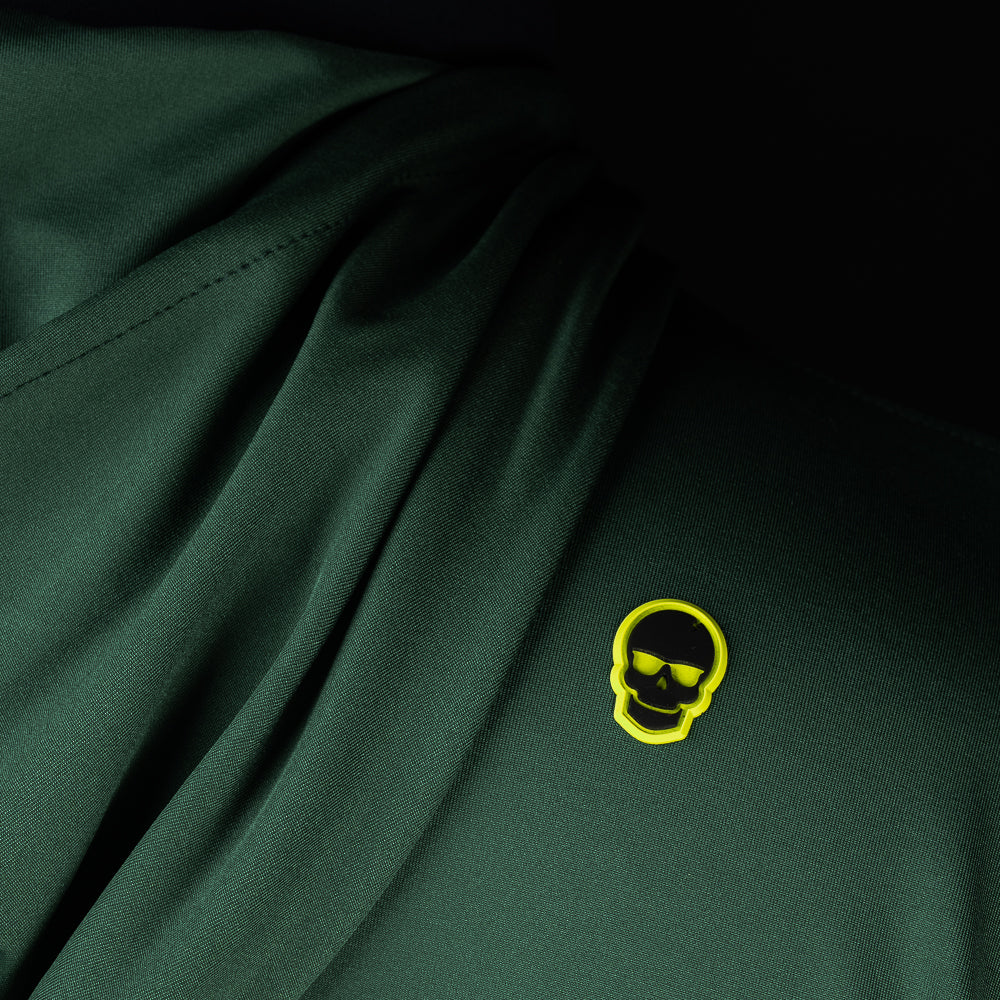 Close-up of embroidered SWAG Golf skull logo on Olive Player Hoodie performance golf hoodie