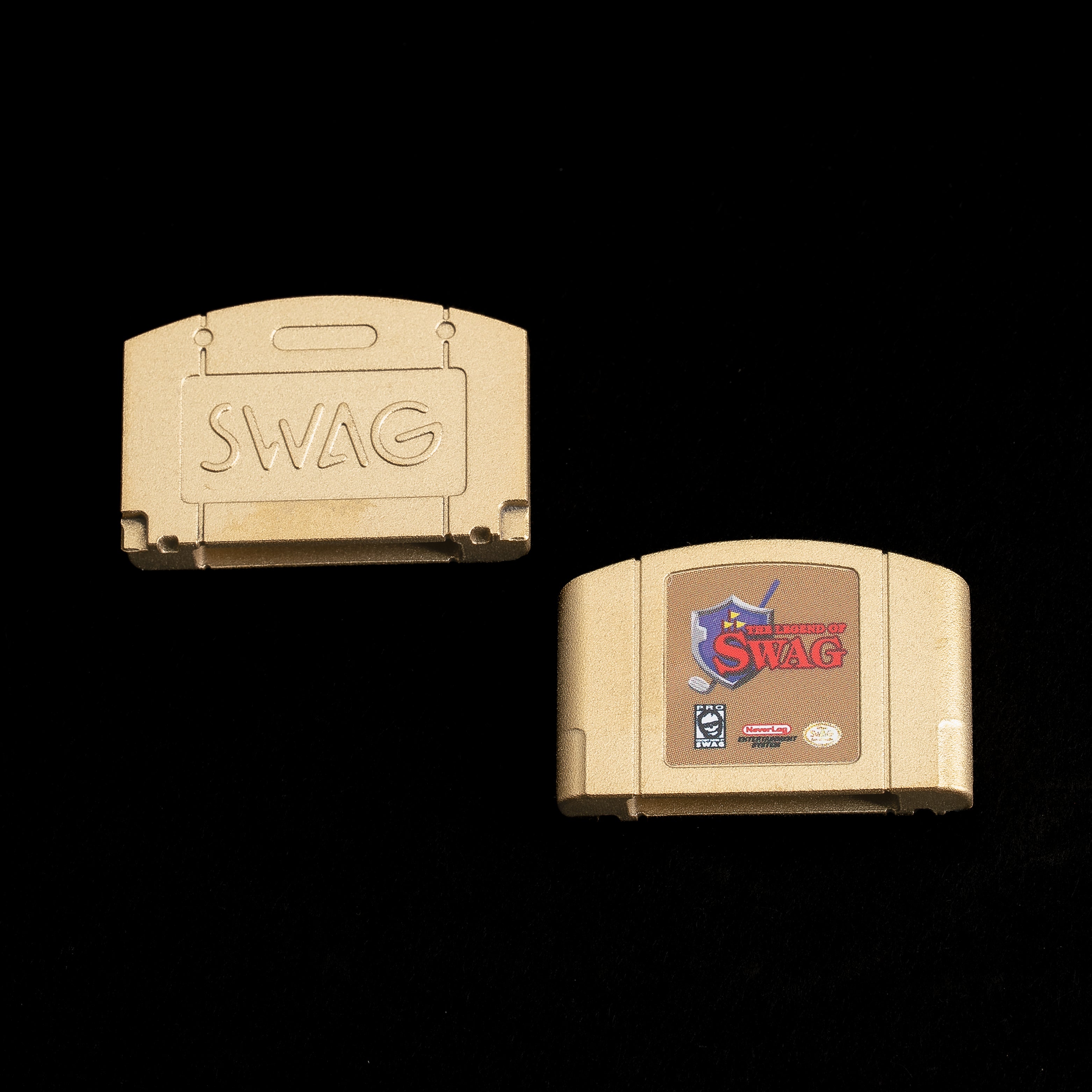 Brass ball marker shaped like a retro game cartridge with Ocarina of Swag fantasy artwork and SWAG logo.
