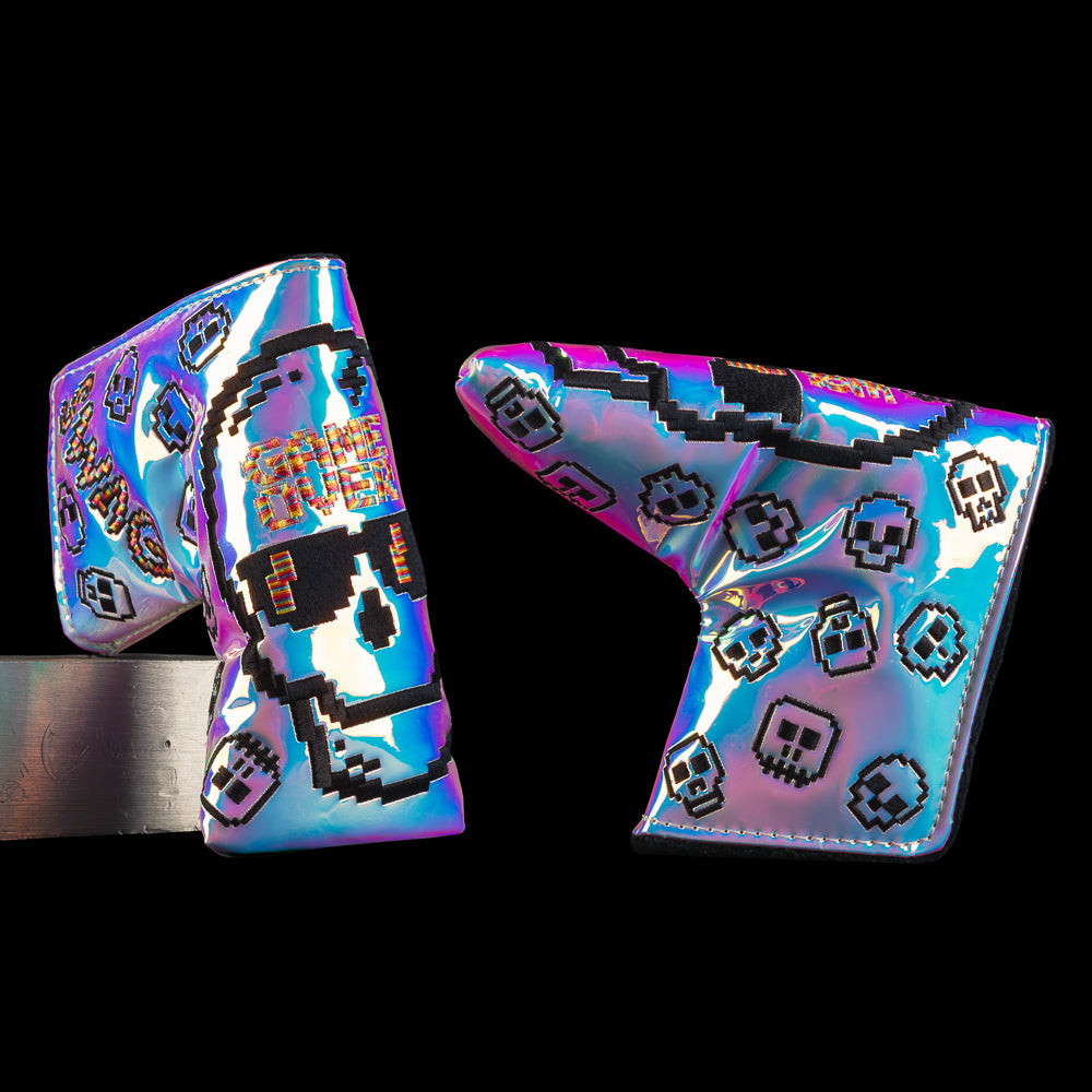 Pearlescent blade cover with pixel skull graphic, floating mini skull icons, and a rainbow gradient finish. Pixelated "GAME OVER" quote.